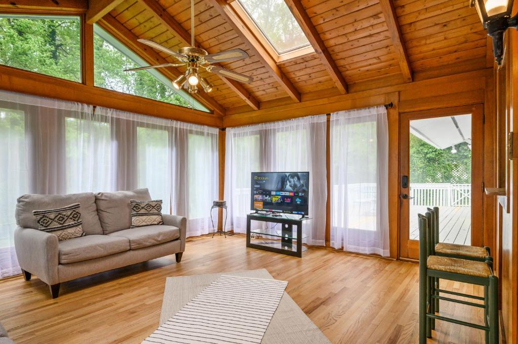 a living room with a couch and a flat screen tv at Enjoy This Roomy Cabin Style 5BR With A Pool Table in Marietta