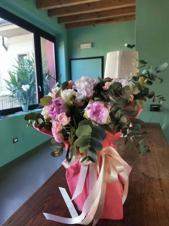 a bouquet of flowers in a vase on a table at LT - Room's Bed & Living in Monza