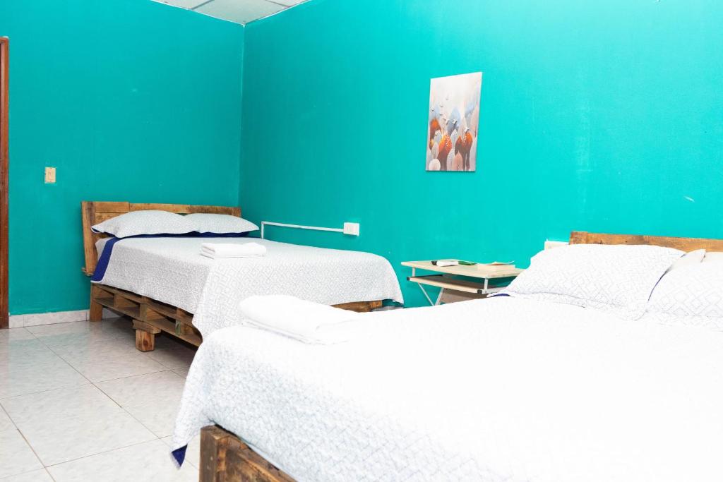 A bed or beds in a room at Hostal Familiar Argeñal