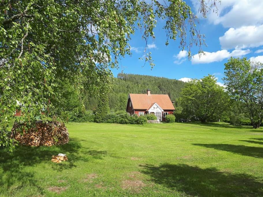 a house in the middle of a green field at Countryside Holiday home "Our Little Farm" in Hagfors