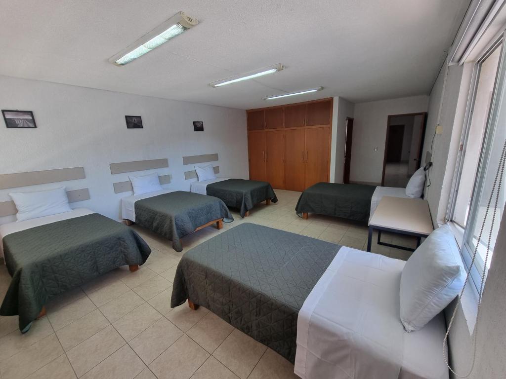 Postel nebo postele na pokoji v ubytování Residencia Ximatario