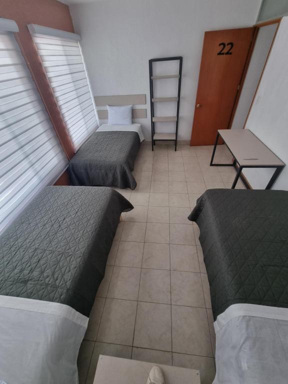 Postel nebo postele na pokoji v ubytování Residencia Ximatario