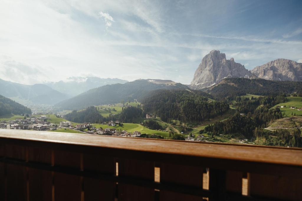 a view of a mountain range from a balcony at Oberaldoss Residence Wellness in Santa Cristina in Val Gardena