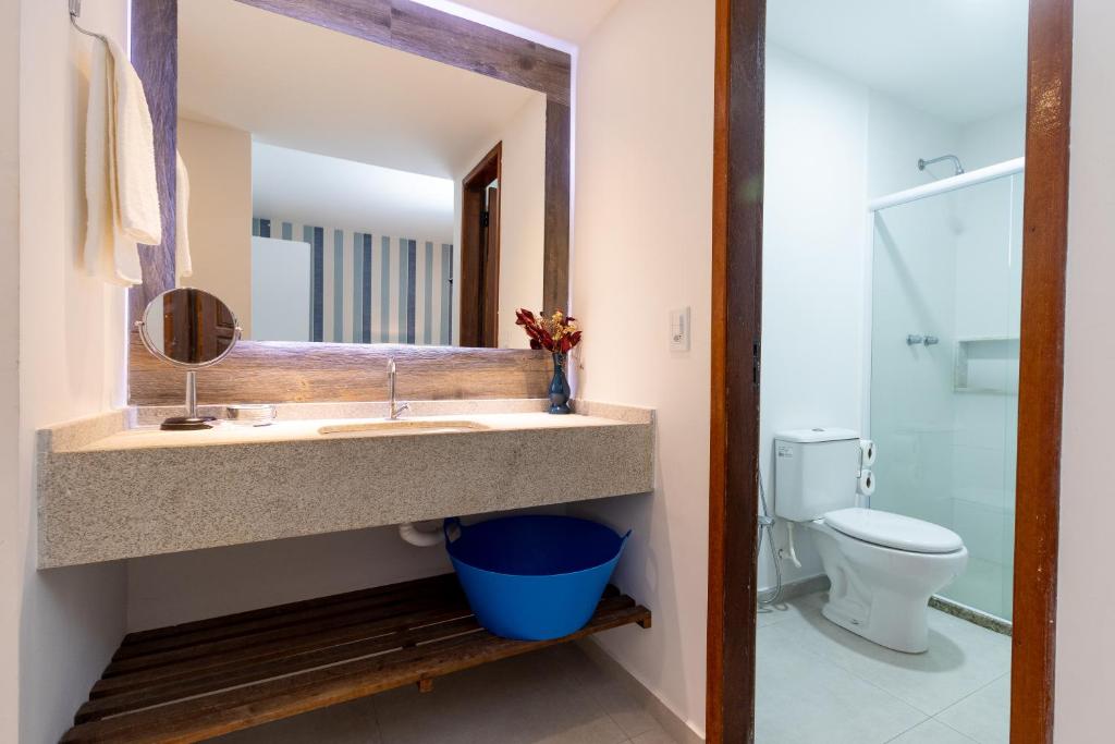 a bathroom with a sink and a toilet at Pousada do Timoneiro in Arraial do Cabo