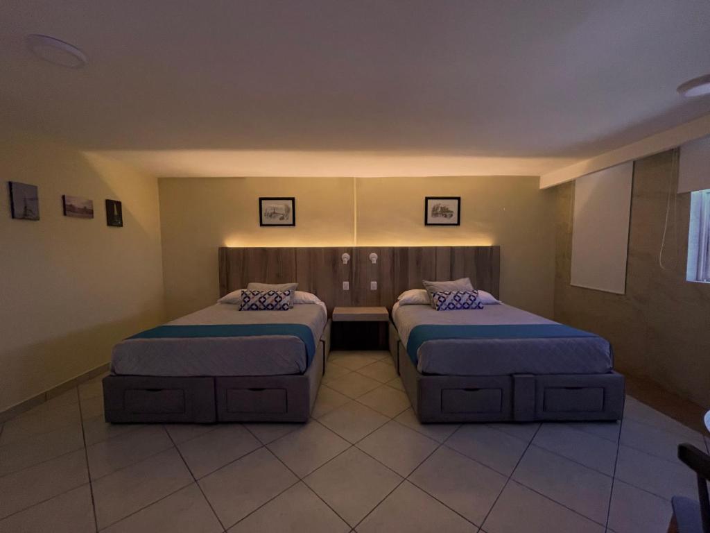 Postel nebo postele na pokoji v ubytování EXECUTIROOMS VERACRUZ