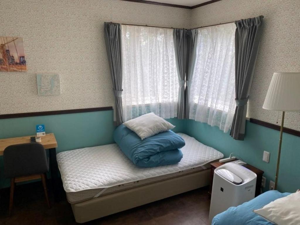 a small room with a bed with a pillow on it at Ashigarashimo-gun - Hotel - Vacation STAY 53631v in Onsensō
