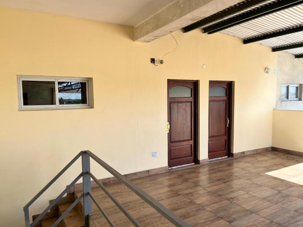 an empty room with two doors and a staircase at Dtos las brisas in La Banda