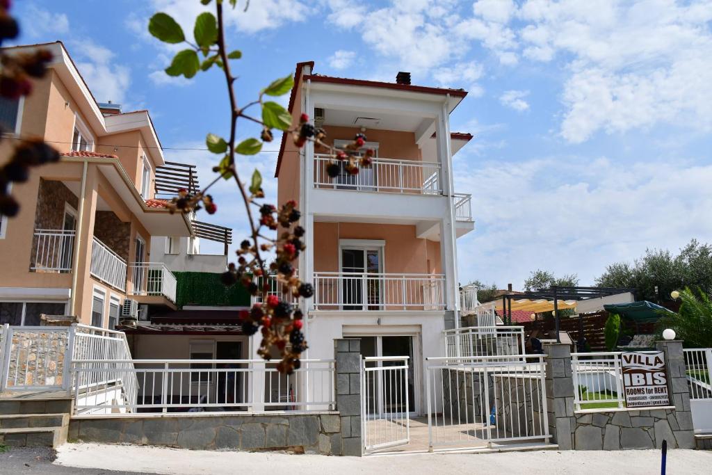 a building with white balconies on the side of it at VILLA IBIS THASSOS in Chrysi Ammoudia