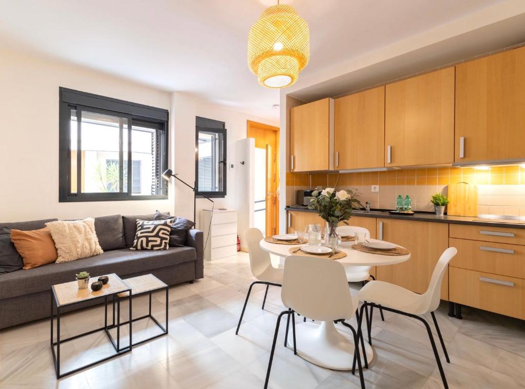 a kitchen and living room with a couch and a table at Great location in the historical center in Seville