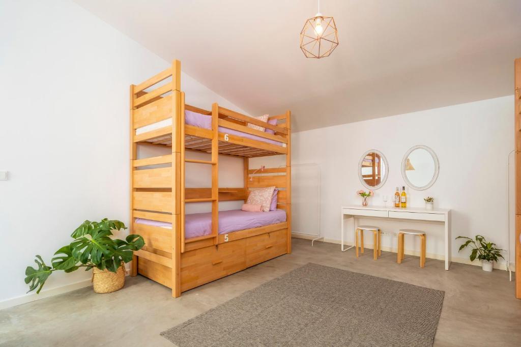 a bedroom with a bunk bed and a desk at Female Hostel in Faro
