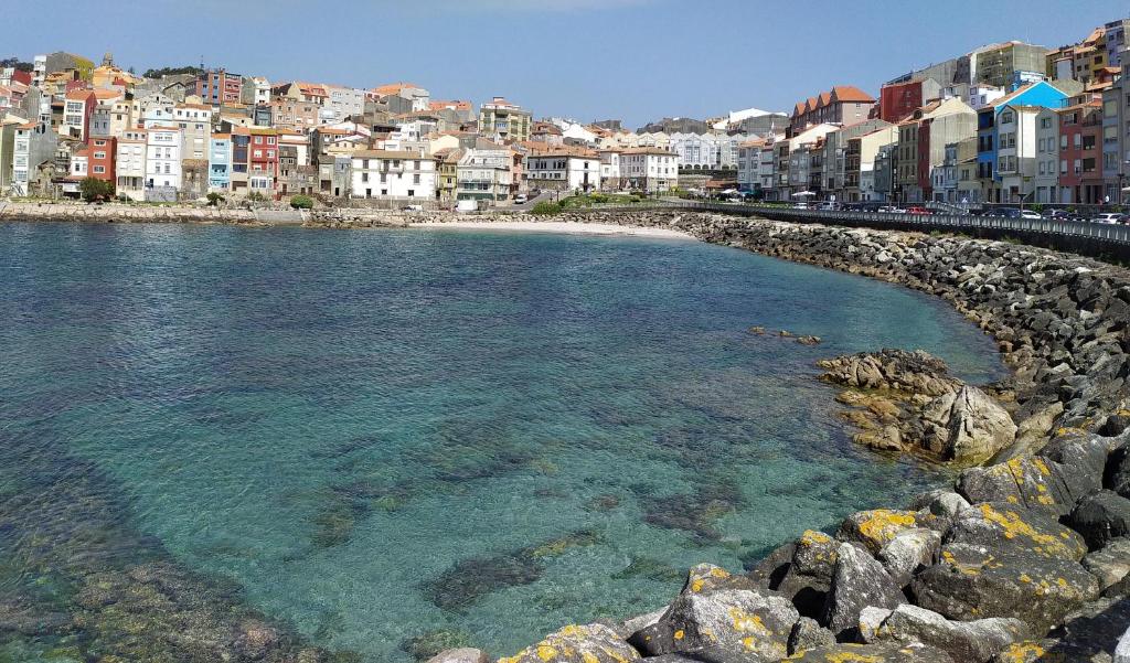 widok na plażę z budynkami i wodą w obiekcie Rua GALICIA w mieście A Guarda