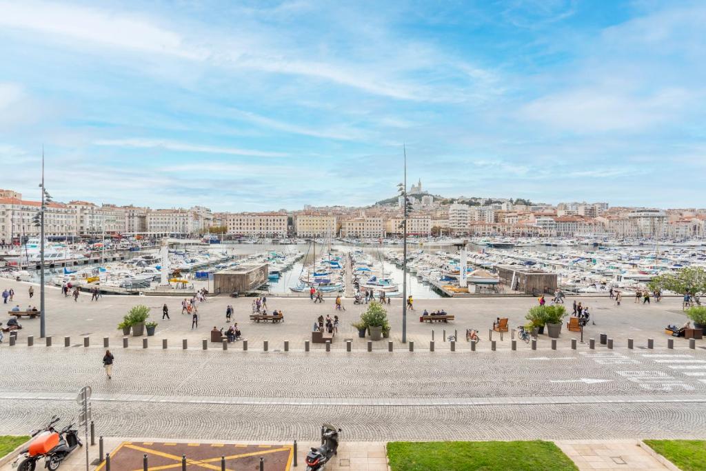 a marina with many boats in a harbor at Hostel Ambassade Bretonne Vieux-Port in Marseille