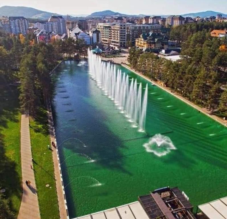 an aerial view of a fountain in a river at Lux Apartman Boris in Zlatibor