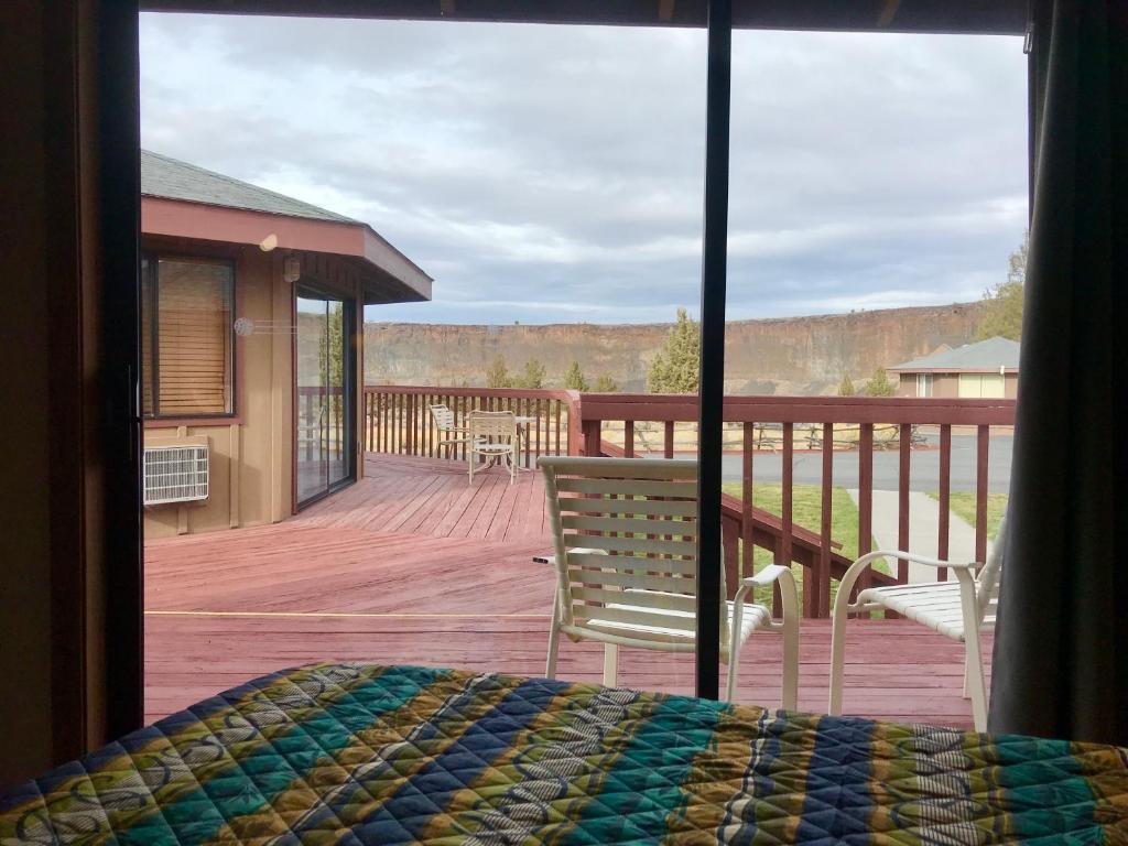 a room with a view of a deck with a bed at Smith Rock Resort in Terrebonne