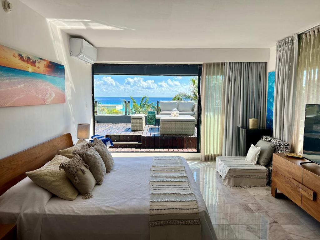 a bedroom with a large bed and a living room at Xcanan Loft On Park Royal, the best area in Cancún right on the beach in Cancún