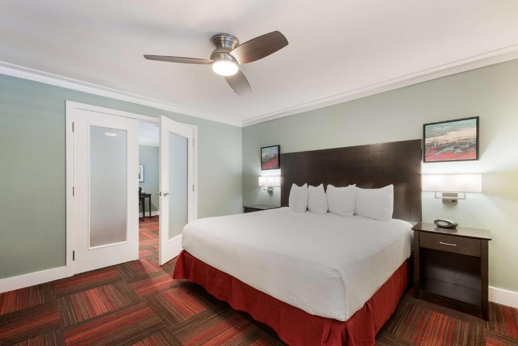 a hotel room with a bed and a ceiling fan at BEST WESTERN the Inn of Los Gatos in Los Gatos