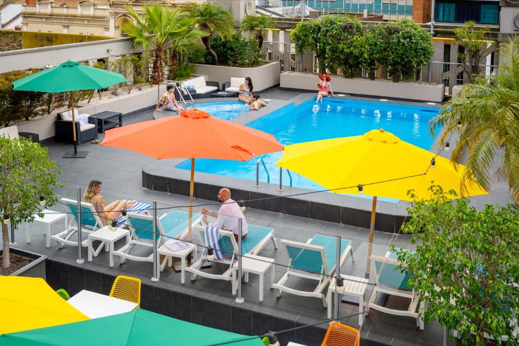 an overhead view of a pool with umbrellas at Hotel Grand Chancellor Adelaide in Adelaide