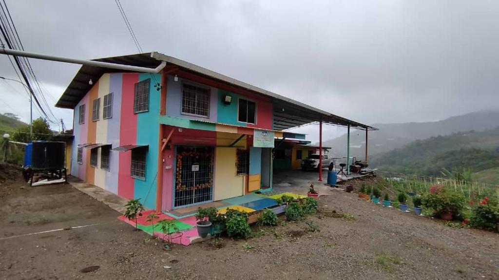 a colorful house sitting on the side of a road at MAK Homestay UPSTAIRS with 5 Bedrooms in Kundasang