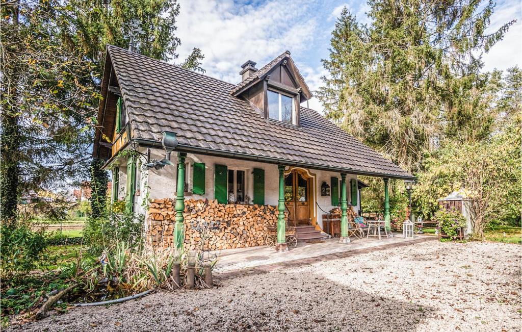 a small green house with a stone wall at Stunning Home In Knringue With Sauna And 1 Bedrooms in Knoeringue