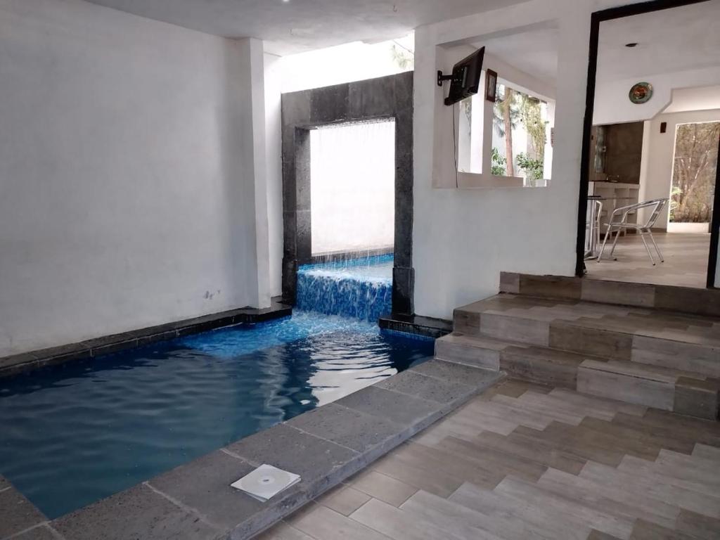 a swimming pool with blue water in a house at Black & White casa privada con alberca in Monterrey