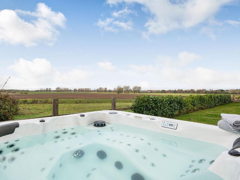a jacuzzi tub with a view of a field at Hill Crest in Dunston