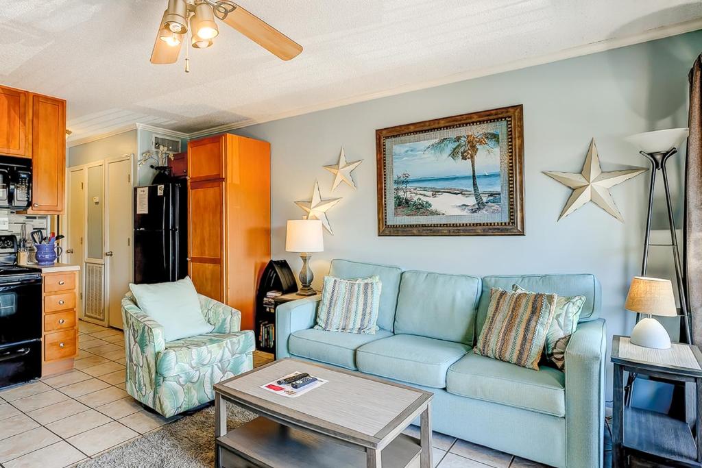 a living room with a blue couch and a table at HH Beach & Tennis 245B in Hilton Head Island