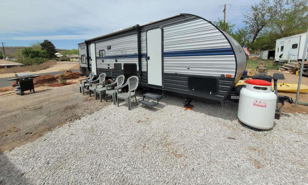 an rv with chairs and a grill and a drum at 2020 Camper fully hooked-up at St. George RV Park! in St. George