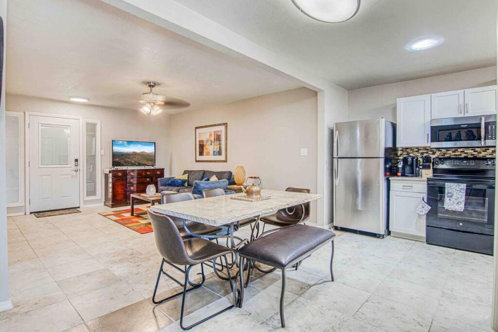 a kitchen and living room with a table and chairs at My Cozy Duplex A in the Heart of West Side in El Paso