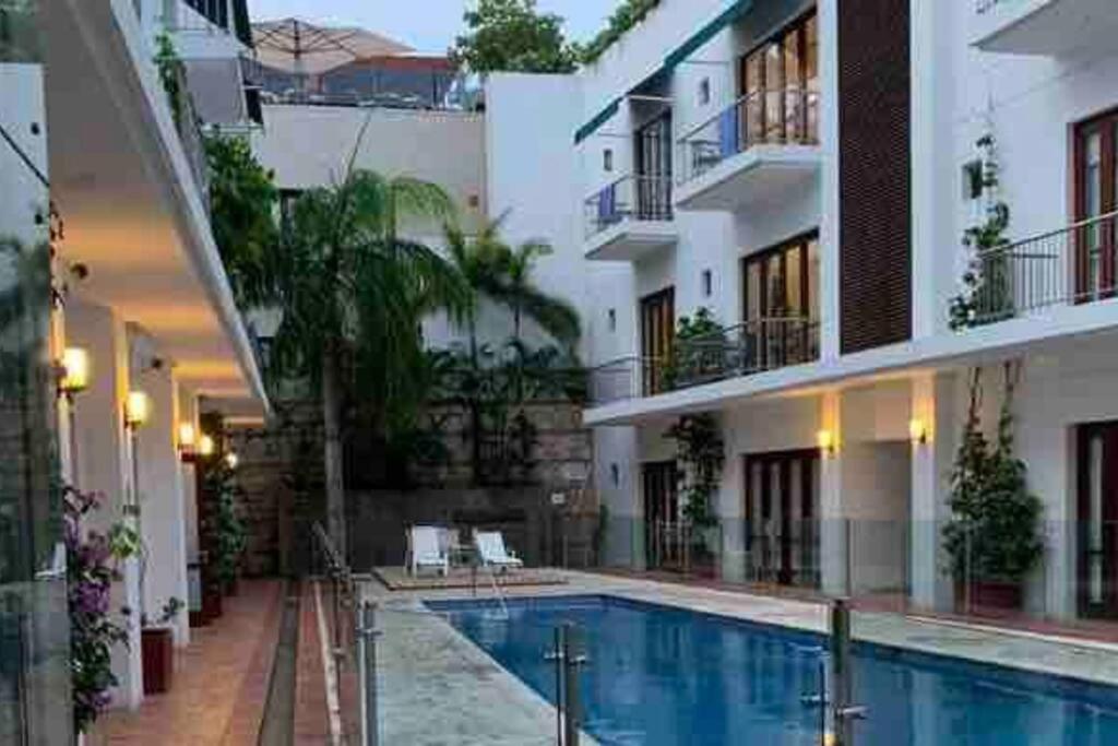 a swimming pool in the middle of a building at 212 Cartagena Walled City Magical Apt in Cartagena de Indias