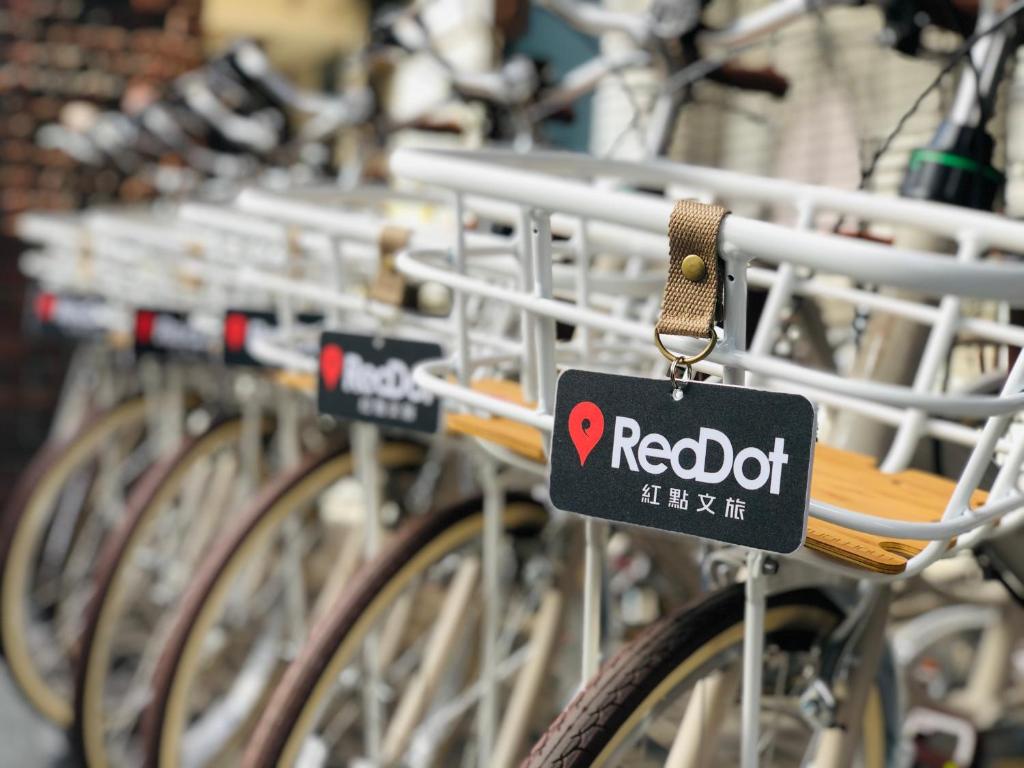 a rack of bikes with a red dot sign on them at Reddot Hotel in Taichung