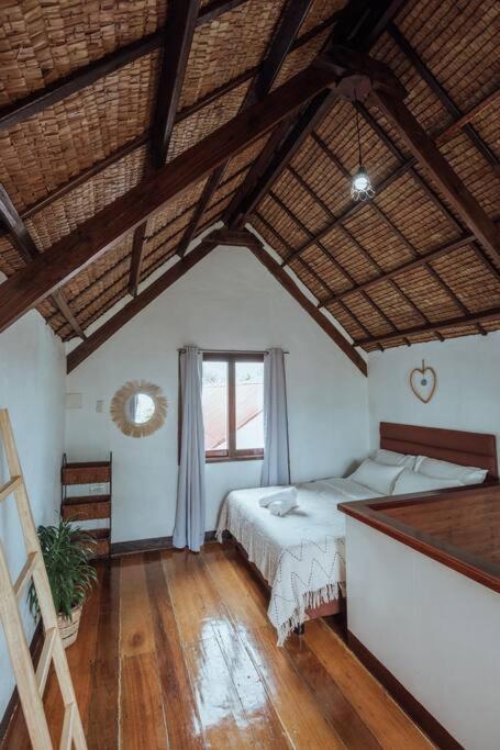 a bedroom with two beds and a wooden floor at BayayTagoSiargao in General Luna