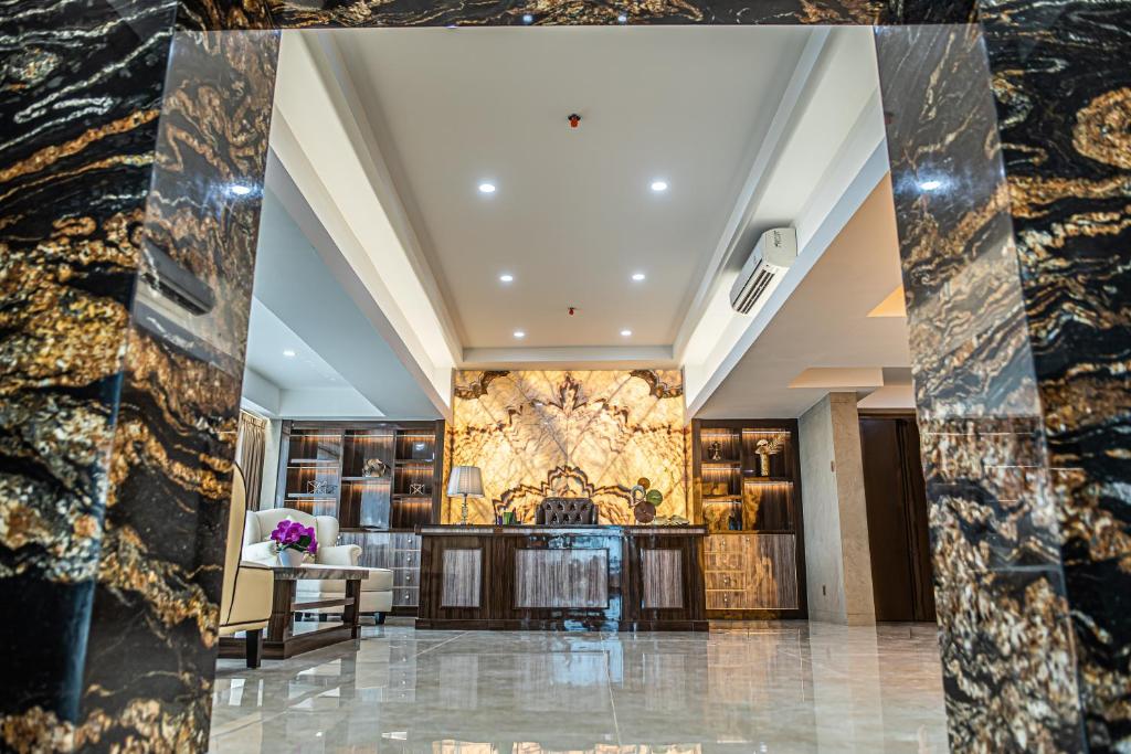 a lobby of a hotel with a marble wall at Dream of Aventus Hotel Kuta in Kuta