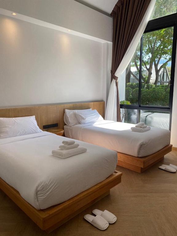 Postel nebo postele na pokoji v ubytování River Kwai Kiri Resort