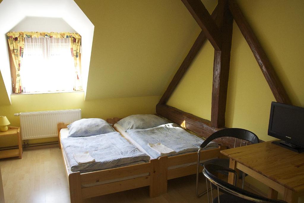 Postel nebo postele na pokoji v ubytování Penzion Ambrozie
