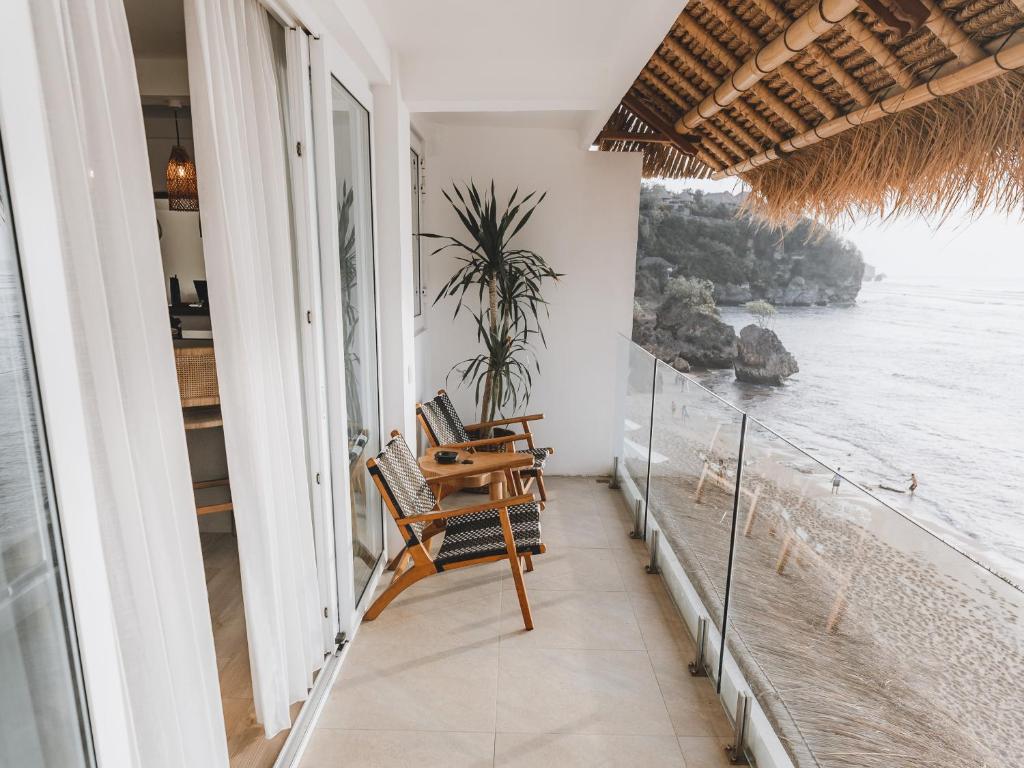 a balcony with a view of the ocean at Legends Beachfront Resort in Uluwatu