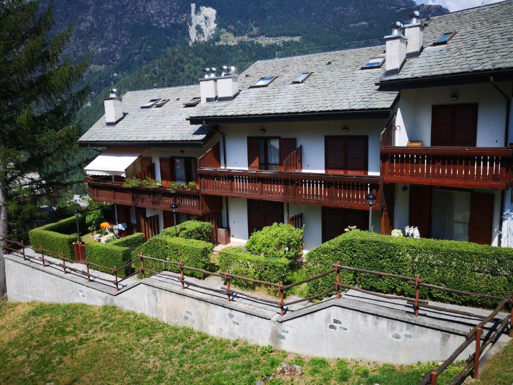 a large house with balconies and bushes on a hill at Chalet Luna in Caspoggio