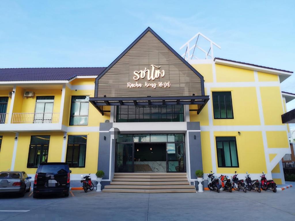 a yellow building with motorcycles parked in front of it at โรงแรมรชาโขง Racha Khong Hotel in Nakhon Phanom