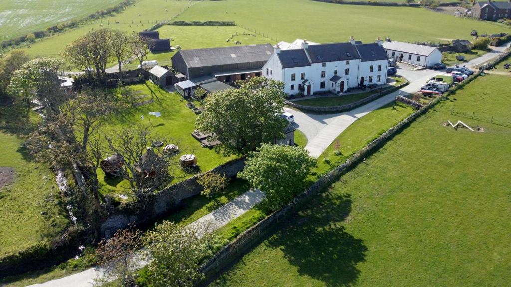 an aerial view of a large white house in a field at Knockaloe Beg Farm in Patrick