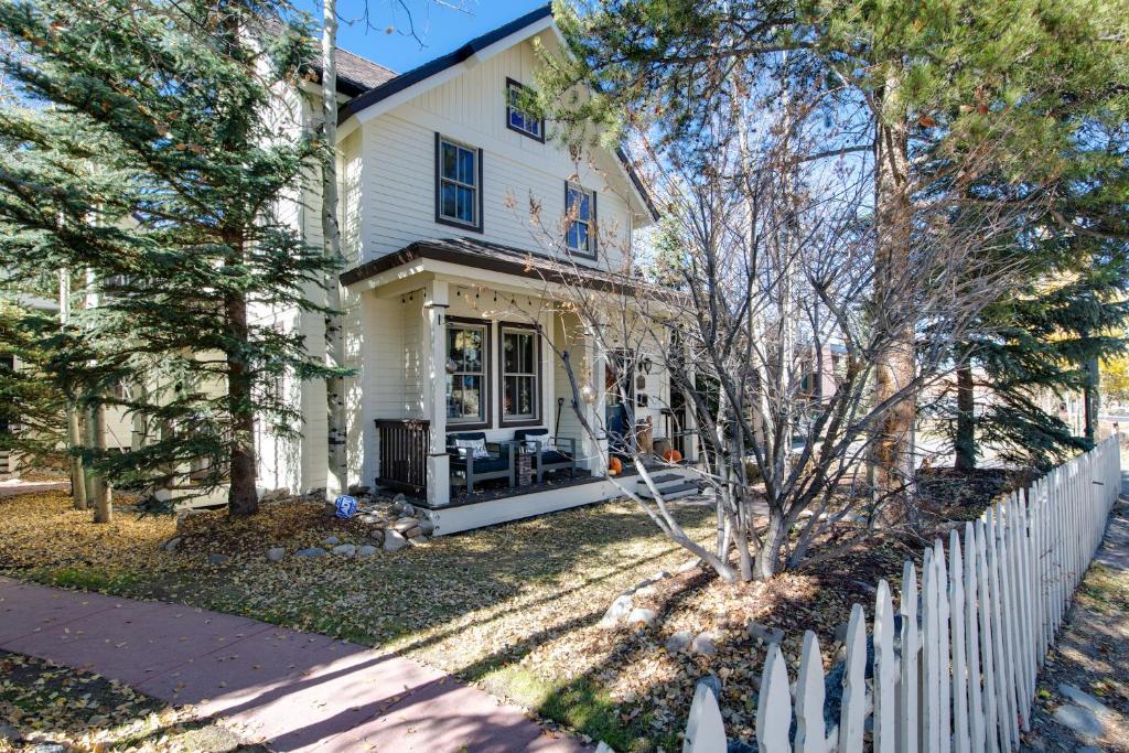 a white fence in front of a white house at Ridge Street Chalet Home: Historic District Charm in Breckenridge