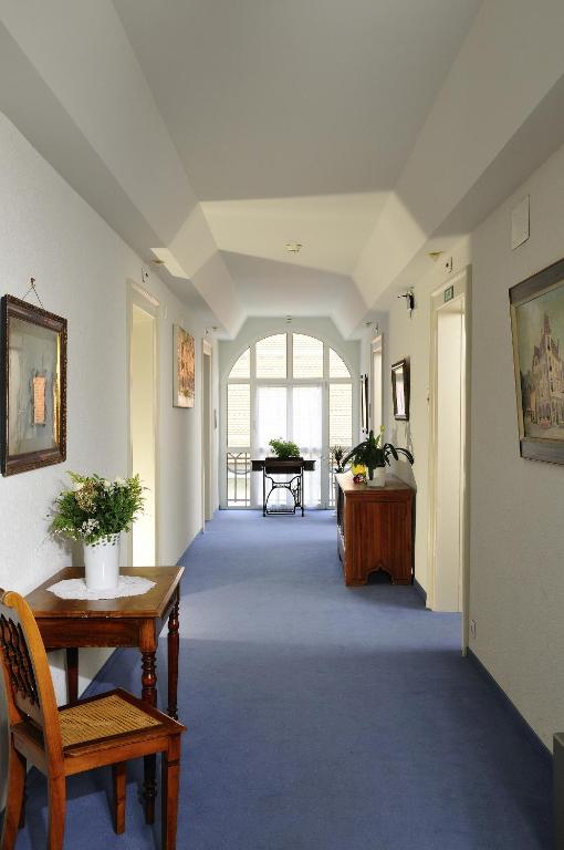 a hallway with a table and chairs in a building at Hotel Lötschberg in Interlaken