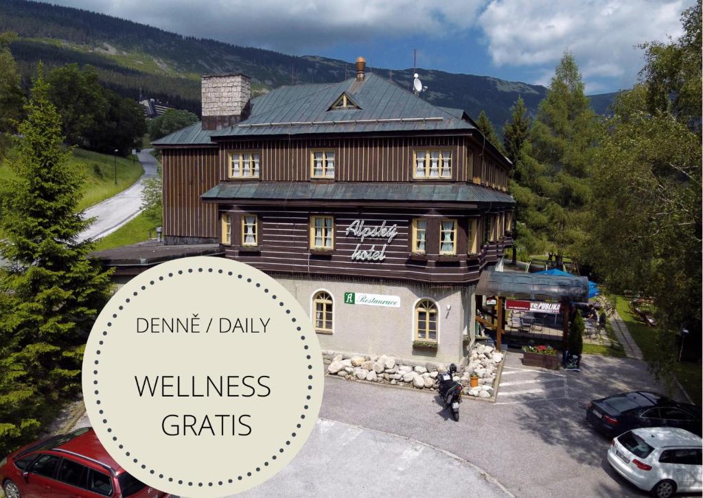 a building with a sign that reads wellness grids at Alpský Hotel in Špindlerův Mlýn