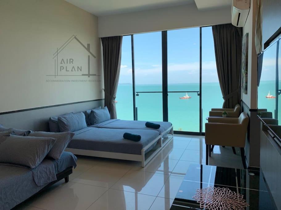 a bedroom with a bed and a couch and glass windows at PD D'Wharf Premium Suite - Full Seaview (Up to 6 Pax) in Port Dickson