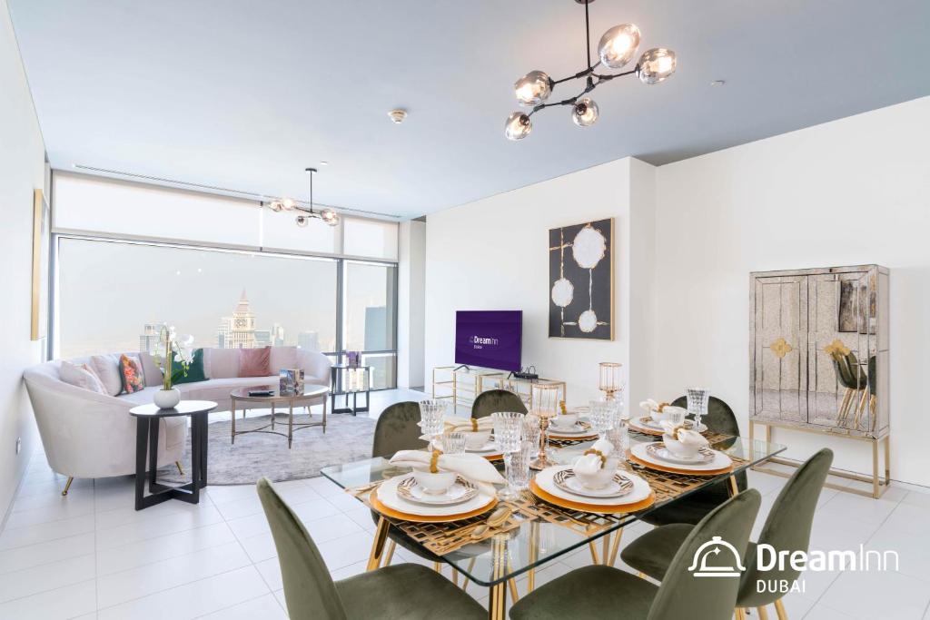 a dining room with a table and chairs in a living room at Dream Inn Apartments - Index Tower in Dubai