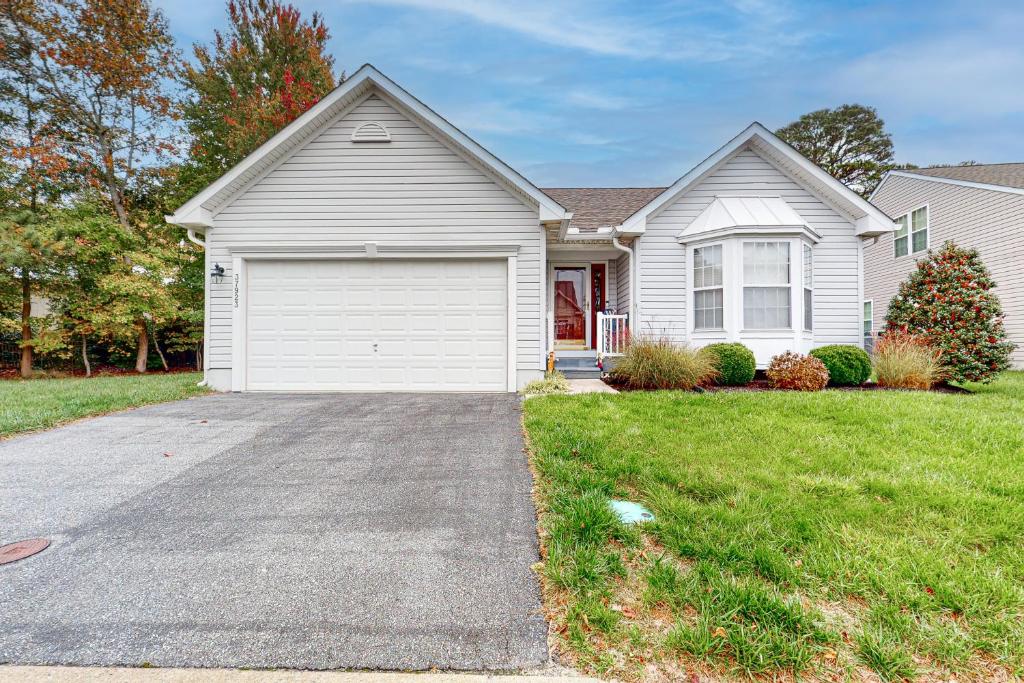 a white house with a garage in a yard at South Hampton --- 37923 Greenwich Ln in Ocean View