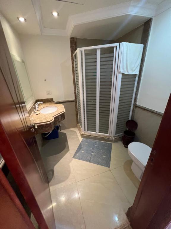 a bathroom with a shower and a toilet and a sink at Palm Resort in Sharm El Sheikh