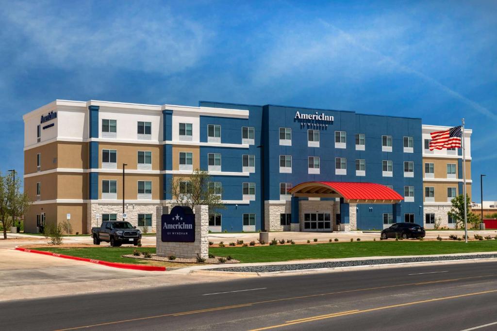 a building with an american airlines sign in front of it at AmericInn by Wyndham San Angelo in San Angelo