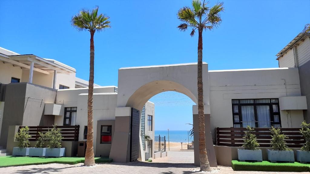 two palm trees in front of a building at Atlantic Villa Boutique Guesthouse in Swakopmund