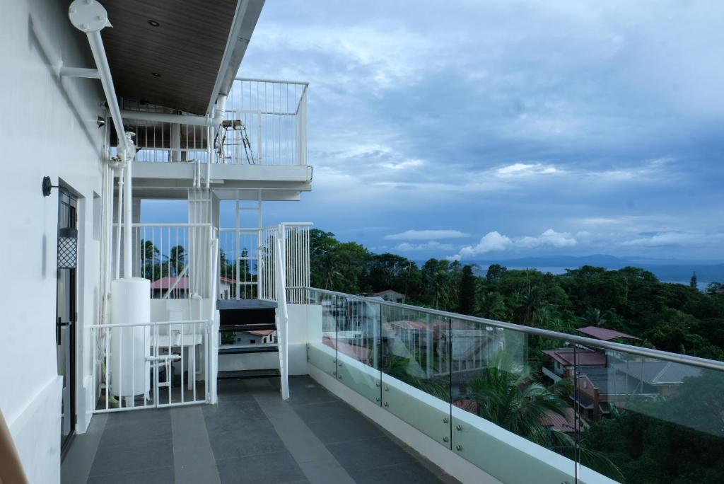 a balcony with a view of the ocean at El Bien Hotel Tagaytay in Tagaytay