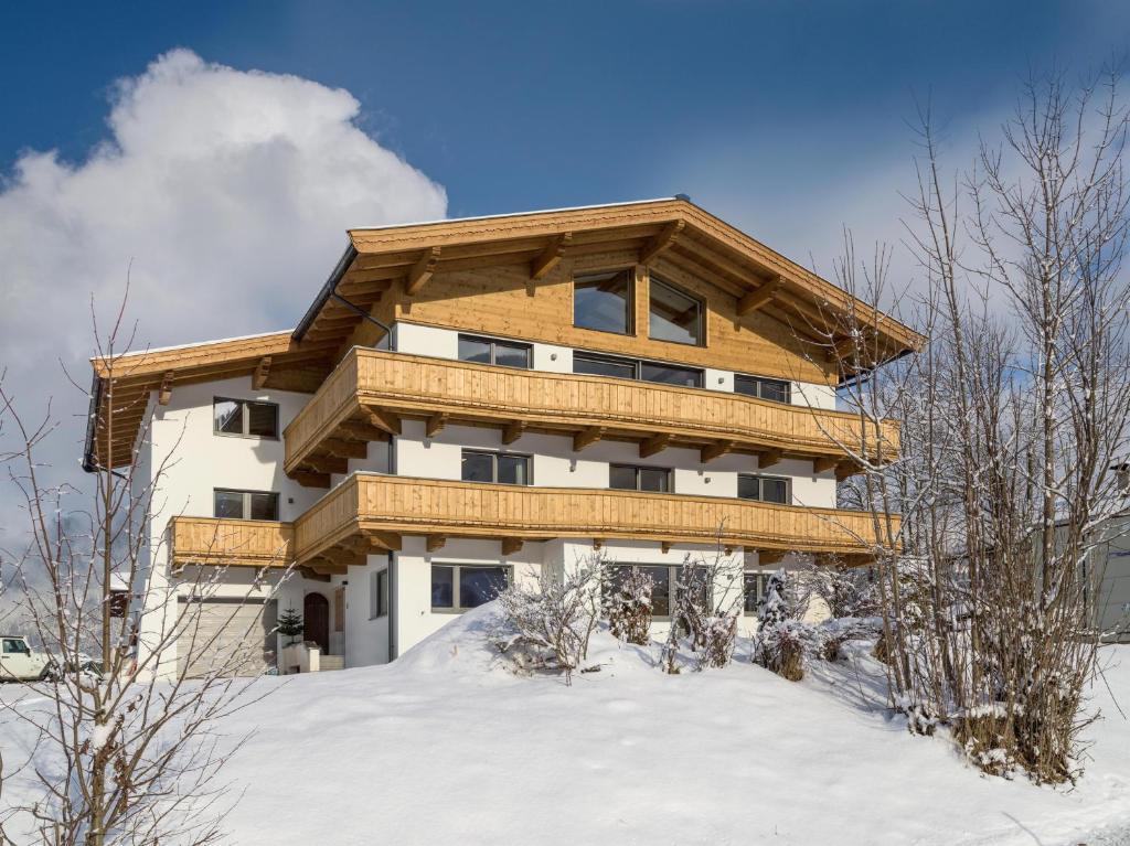 a large building with snow in front of it at Haus Seisl in Söll