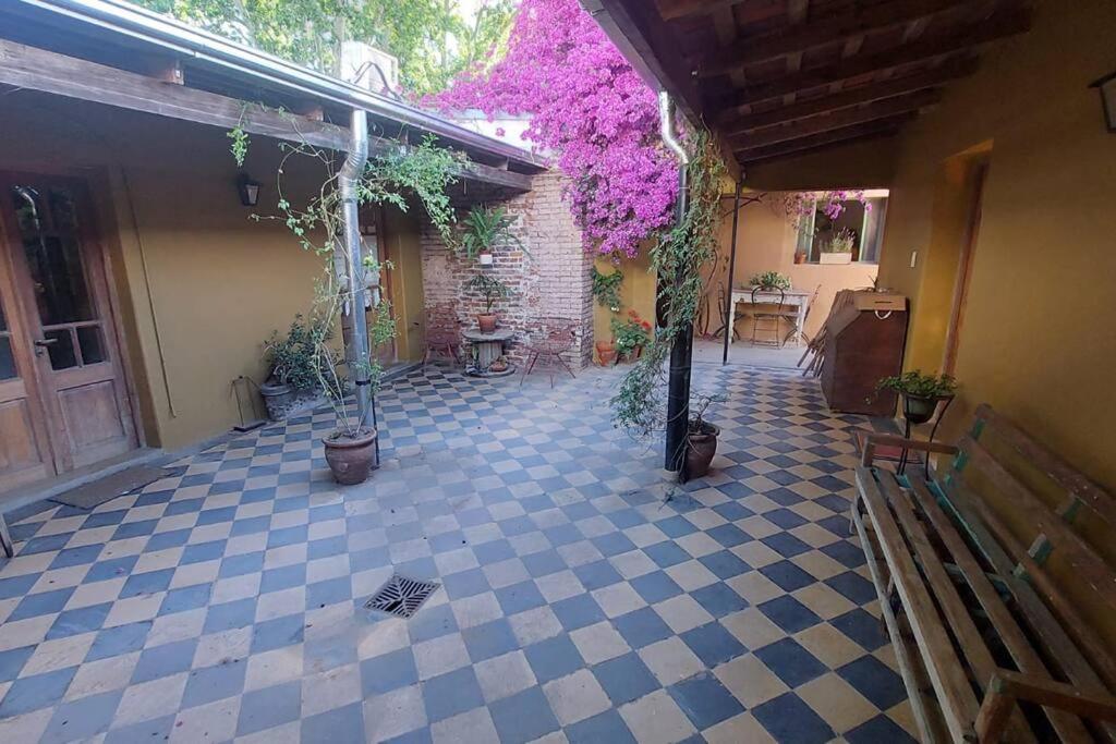 un patio al aire libre con suelo de baldosa azul y blanco en Casa Vieytes en San Antonio de Areco